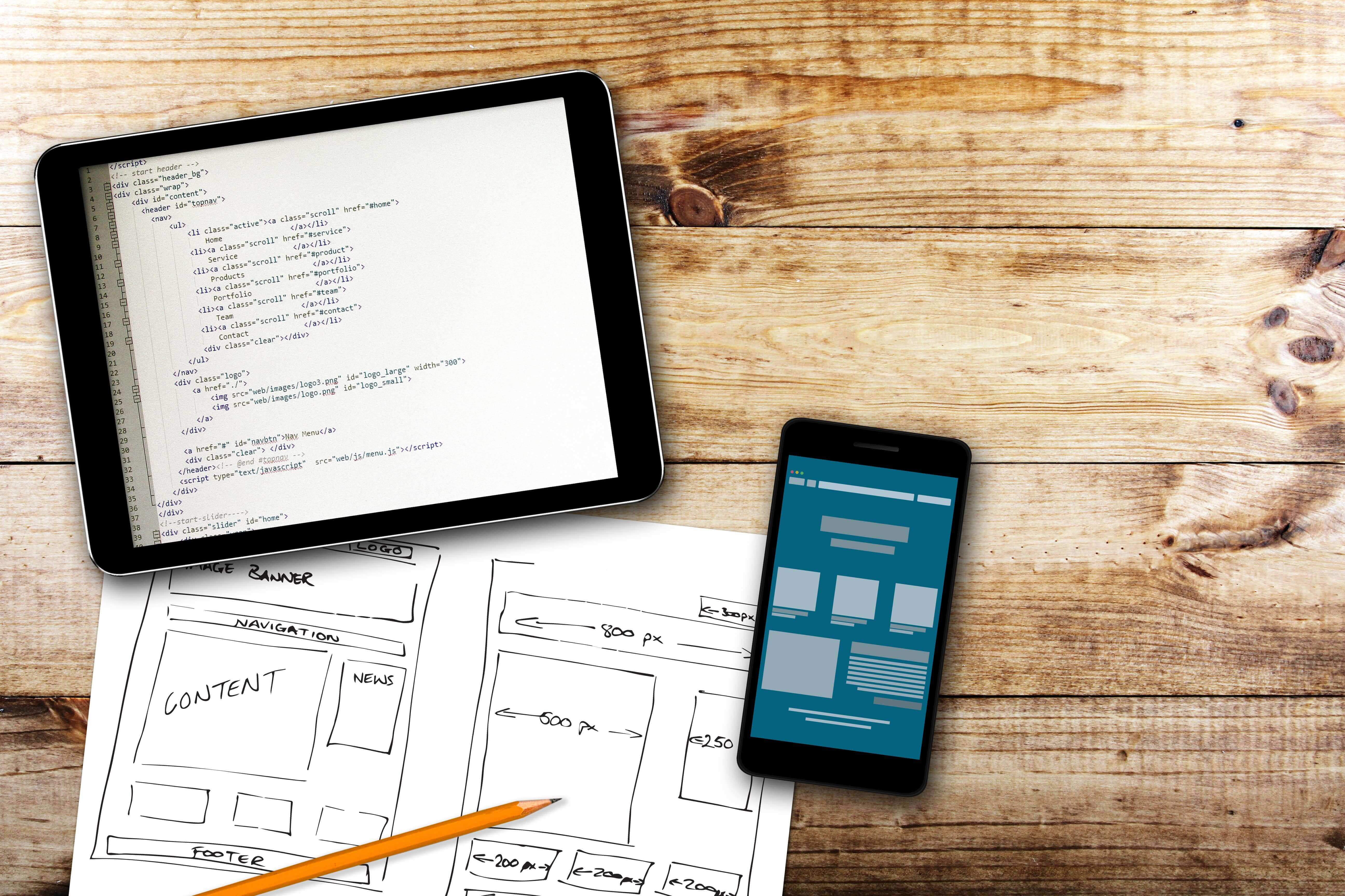 codes and app design shown on tablet and mobile device